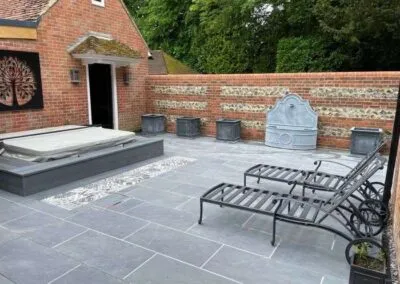 Outdoor patio area in garden and brick wall installation
