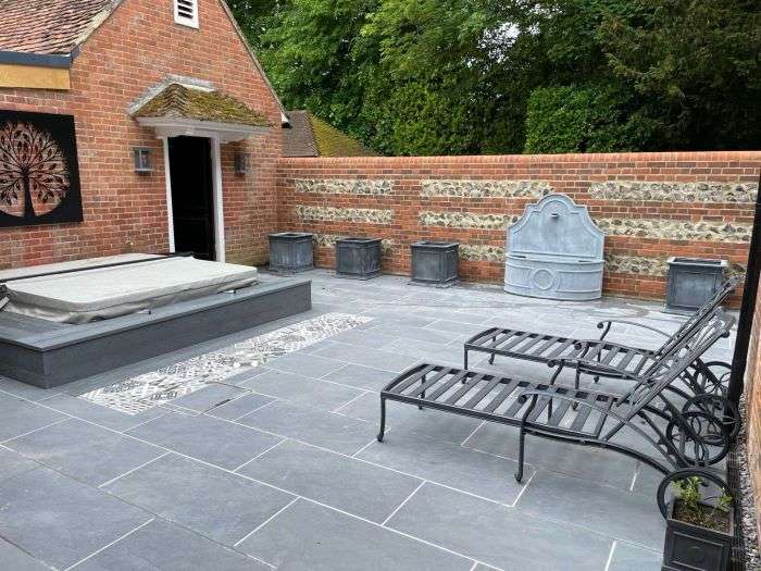 Outdoor patio area in garden and brick wall installation